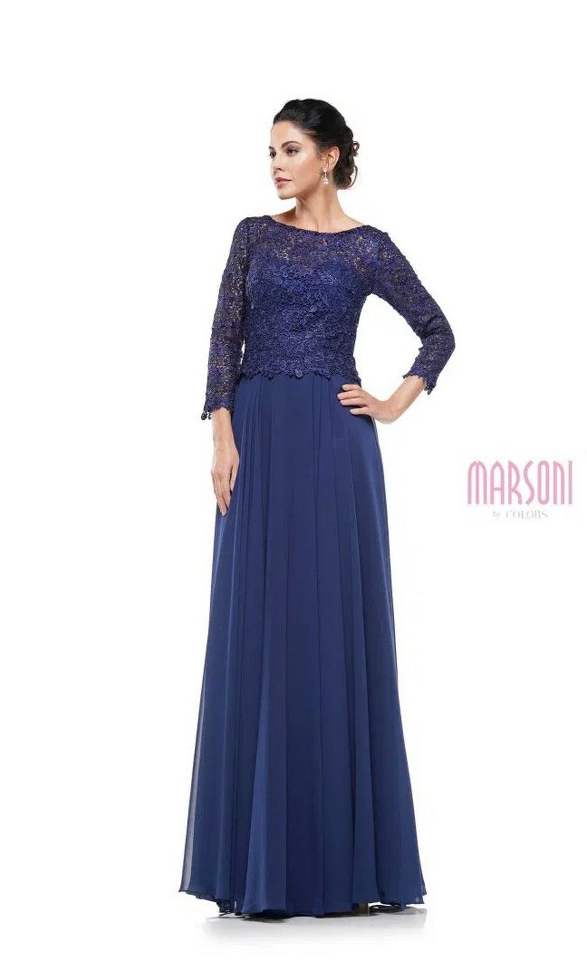 A woman models the Marsoni M223 long formal dress in navy, featuring a lace bodice, three-quarter sleeves, and a flowing chiffon skirt, standing against a white background.